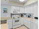 A bright white kitchen provides ample counter space and includes modern appliances for a functional cooking area at 4103 N Ocean Blvd. # 707, North Myrtle Beach, SC 29582