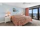 Relaxing main bedroom with balcony access and ocean views, features neutral tones and comfortable bedding at 4103 N Ocean Blvd. # 707, North Myrtle Beach, SC 29582