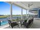 This covered patio offers a beautiful waterfront view, comfortable seating, and a fan for outdoor enjoyment at 433 Saint Julian Ln., Myrtle Beach, SC 29579