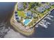 Aerial view of waterfront community featuring pool, marina and clubhouse at 4648 Lightkeepers Way # 39A, Little River, SC 29566