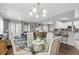 Open dining room featuring a modern chandelier, glass table, and hardwood floors at 4648 Lightkeepers Way # 39A, Little River, SC 29566