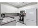 Bright kitchen with white cabinetry, stainless steel appliances, and a modern faucet at 4648 Lightkeepers Way # 39A, Little River, SC 29566