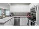 Bright kitchen featuring white cabinetry and stainless steel appliances at 4648 Lightkeepers Way # 39A, Little River, SC 29566