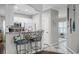 Eat-in kitchen with white cabinets, a stainless steel microwave, and a stylish breakfast bar at 4648 Lightkeepers Way # 39A, Little River, SC 29566