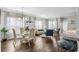 Open-concept living area with a glass dining table and comfortable seating at 4648 Lightkeepers Way # 39A, Little River, SC 29566