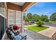 Cozy covered porch with comfortable seating and well-manicured front lawn at 4648 Lightkeepers Way # 39A, Little River, SC 29566