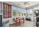 Bright sunroom featuring plenty of natural light, tile floors, and neutral decor at 4648 Lightkeepers Way # 39A, Little River, SC 29566