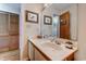 Bathroom showcasing a vanity with a white countertop, framed mirror, and wood-look flooring at 510 Fairwood Lakes Dr. # 15-I, Myrtle Beach, SC 29588