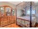 Charming bedroom with a four-poster bed, antique dresser, and warm hardwood flooring at 510 Fairwood Lakes Dr. # 15-I, Myrtle Beach, SC 29588