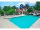 A beautiful pool with clear blue water, chairs and nearby shaded areas at 510 Fairwood Lakes Dr. # 15-I, Myrtle Beach, SC 29588