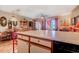 Open-concept kitchen with bar seating adjacent to a brightly decorated living room with outside patio access at 510 Fairwood Lakes Dr. # 15-I, Myrtle Beach, SC 29588