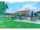 Patio view of community pond with wooden deck, picnic tables, and condo buildings at 510 Fairwood Lakes Dr. # 15-I, Myrtle Beach, SC 29588