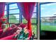 Sunroom with large windows, red seating, and a picturesque lake view at 510 Fairwood Lakes Dr. # 15-I, Myrtle Beach, SC 29588