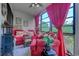 Comfortable sunroom with large windows offering a serene outdoor view and bright red seating at 510 Fairwood Lakes Dr. # 15-I, Myrtle Beach, SC 29588