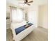 Well-lit bedroom featuring wood-look flooring, a ceiling fan and white built-in shelves at 541 Irees Way, Longs, SC 29568