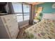 Bright bedroom with a large window, chest of drawers, and a seaside quilt at 5511 Ocean Blvd. N # 805, Myrtle Beach, SC 29577