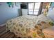 Cozy bedroom with a large window, chest of drawers, and a seashell-patterned bedspread at 5511 Ocean Blvd. N # 805, Myrtle Beach, SC 29577