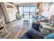 Relax in this living room with ocean views from the sliding glass door and comfortable seating at 5511 Ocean Blvd. N # 805, Myrtle Beach, SC 29577