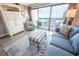 Bright living room with a plush sofa, accent chair, and beachfront balcony access with ocean views at 5511 Ocean Blvd. N # 805, Myrtle Beach, SC 29577
