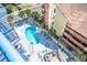 Aerial view of a pool and whirlpool surrounded by lounge chairs and palm trees at 5511 Ocean Blvd. N # 805, Myrtle Beach, SC 29577