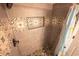 Tiled shower with decorative accents and a pebble floor at 5511 Ocean Blvd. N # 805, Myrtle Beach, SC 29577