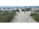A walkway to the beach is framed by lush greenery at 5511 Ocean Blvd. N # 805, Myrtle Beach, SC 29577