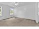 Spacious primary bedroom with carpet flooring, white walls, a ceiling fan, two windows, and natural light at 553 Fox Chase Dr., Conway, SC 29527