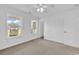 Spacious bedroom with neutral carpet, white walls, a ceiling fan, and bright natural light at 553 Fox Chase Dr., Conway, SC 29527
