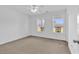 Spacious bedroom featuring neutral carpet, white walls, two windows and a ceiling fan at 553 Fox Chase Dr., Conway, SC 29527