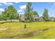 Attractive home with a well-kept lawn and front porch, enhanced by mature trees and landscaping at 553 Fox Chase Dr., Conway, SC 29527