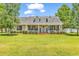 Charming home featuring dormers, a cozy front porch, and a lush green lawn at 553 Fox Chase Dr., Conway, SC 29527