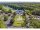 Aerial view of the community clubhouse with fountain, trees, parking, and landscaping at 562 Blue Stem Dr. # 54-F, Pawleys Island, SC 29585