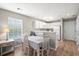 Cozy dining area with wood-style floors adjacent to a kitchen with white cabinets at 562 Blue Stem Dr. # 54-F, Pawleys Island, SC 29585
