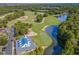 Aerial view of the golf course and lake with blue roof building and parking at 562 Blue Stem Dr. # 54-F, Pawleys Island, SC 29585
