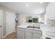 Open kitchen with white countertops, appliances, and a view to the living room at 562 Blue Stem Dr. # 54-F, Pawleys Island, SC 29585