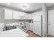 Well-lit kitchen offers white cabinets, modern appliances, and wood-style flooring at 562 Blue Stem Dr. # 54-F, Pawleys Island, SC 29585