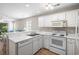 Bright kitchen featuring white appliances, cabinetry, and a view into the living area at 562 Blue Stem Dr. # 54-F, Pawleys Island, SC 29585