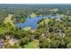 Aerial view of lake with golf course, lush trees, and clubhouse at 562 Blue Stem Dr. # 54-F, Pawleys Island, SC 29585
