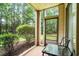 Relaxing screened patio space with a glass table and serene wooded views at 562 Blue Stem Dr. # 54-F, Pawleys Island, SC 29585