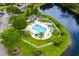 Inviting pool area with lounge chairs, palm trees and a scenic waterfront backdrop at 562 Blue Stem Dr. # 54-F, Pawleys Island, SC 29585