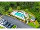 Aerial view of community pool with palm trees, a hot tub, and plenty of parking at 562 Blue Stem Dr. # 54-F, Pawleys Island, SC 29585