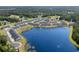 Community aerial view showcasing a serene lake and rows of townhomes with lush greenery at 563 Sea Sparrow St. # 563, Myrtle Beach, SC 29588