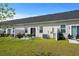 Backyard with a patio, chairs, lush green grass, and views of neighboring units at 563 Sea Sparrow St. # 563, Myrtle Beach, SC 29588