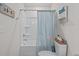 Bright bathroom featuring a shower with blue curtains, white fixtures, and modern decorations at 563 Sea Sparrow St. # 563, Myrtle Beach, SC 29588