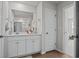 Bathroom with white vanity, spacious mirror, and brown tiled floors at 563 Sea Sparrow St. # 563, Myrtle Beach, SC 29588