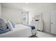 Bright bedroom featuring a queen bed with blue accents, soft carpet, and ample natural light at 563 Sea Sparrow St. # 563, Myrtle Beach, SC 29588