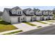 New townhomes featuring attached garages, neatly manicured lawns, and neutral exteriors at 563 Sea Sparrow St. # 563, Myrtle Beach, SC 29588