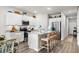 Stylish kitchen with white cabinetry, granite countertops, stainless appliances, and an island with bar stools at 563 Sea Sparrow St. # 563, Myrtle Beach, SC 29588
