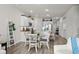 Open-concept kitchen with granite counters, stainless appliances, an eat-in area, and white cabinetry at 563 Sea Sparrow St. # 563, Myrtle Beach, SC 29588