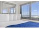 Bright bedroom space featuring a large window with blinds and ocean view at 5905 S Kings Highway # 1206-C, Myrtle Beach, SC 29575